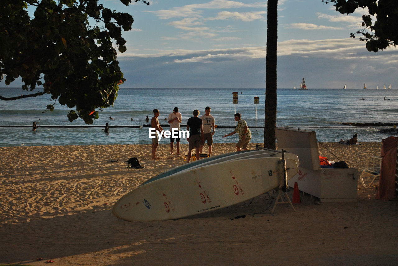 PEOPLE AT BEACH DURING SUNSET