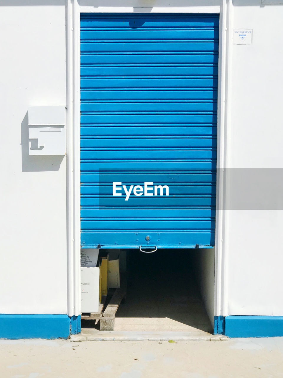 Closed and open blue door of building