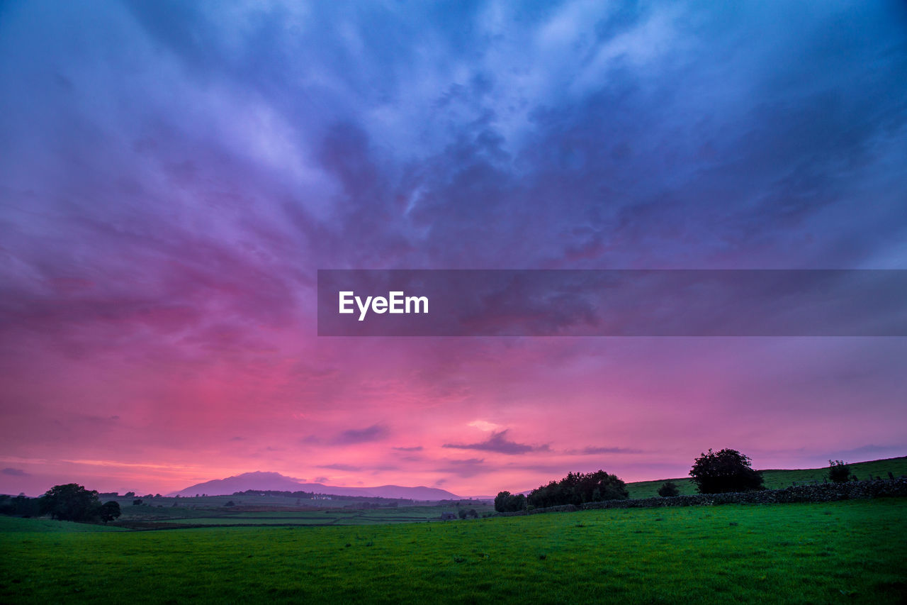 Scenic view of landscape against cloudy sky