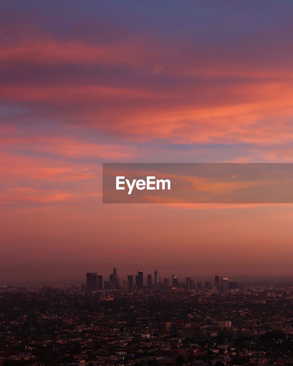 Aerial view of cityscape against romantic sky during sunset