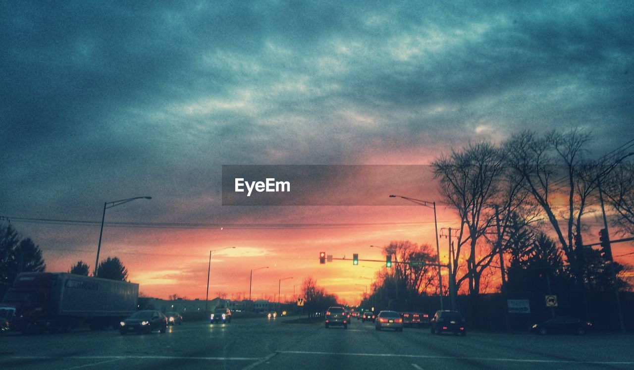 CARS ON STREET AT SUNSET