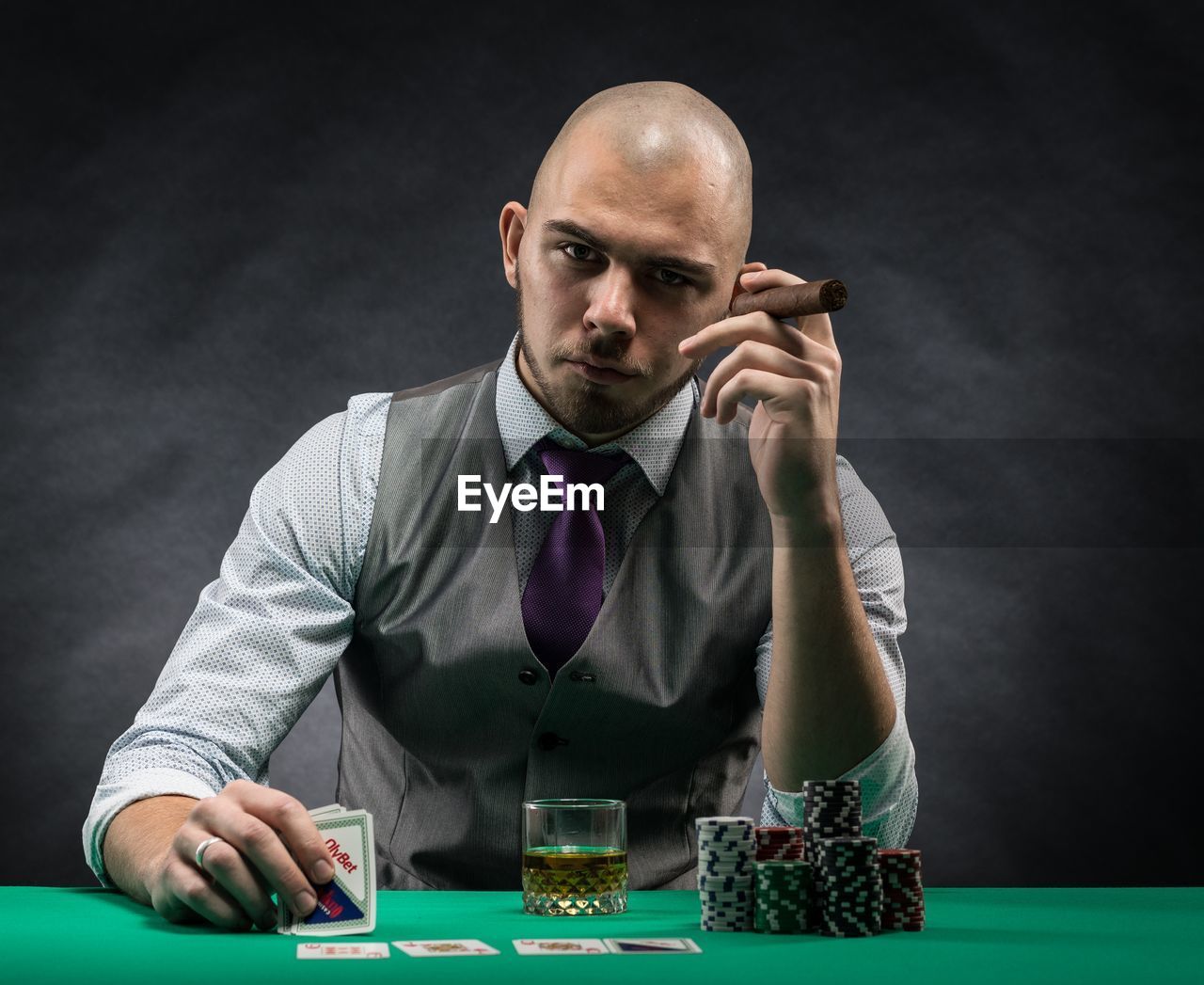 Portrait of man playing with cards at table