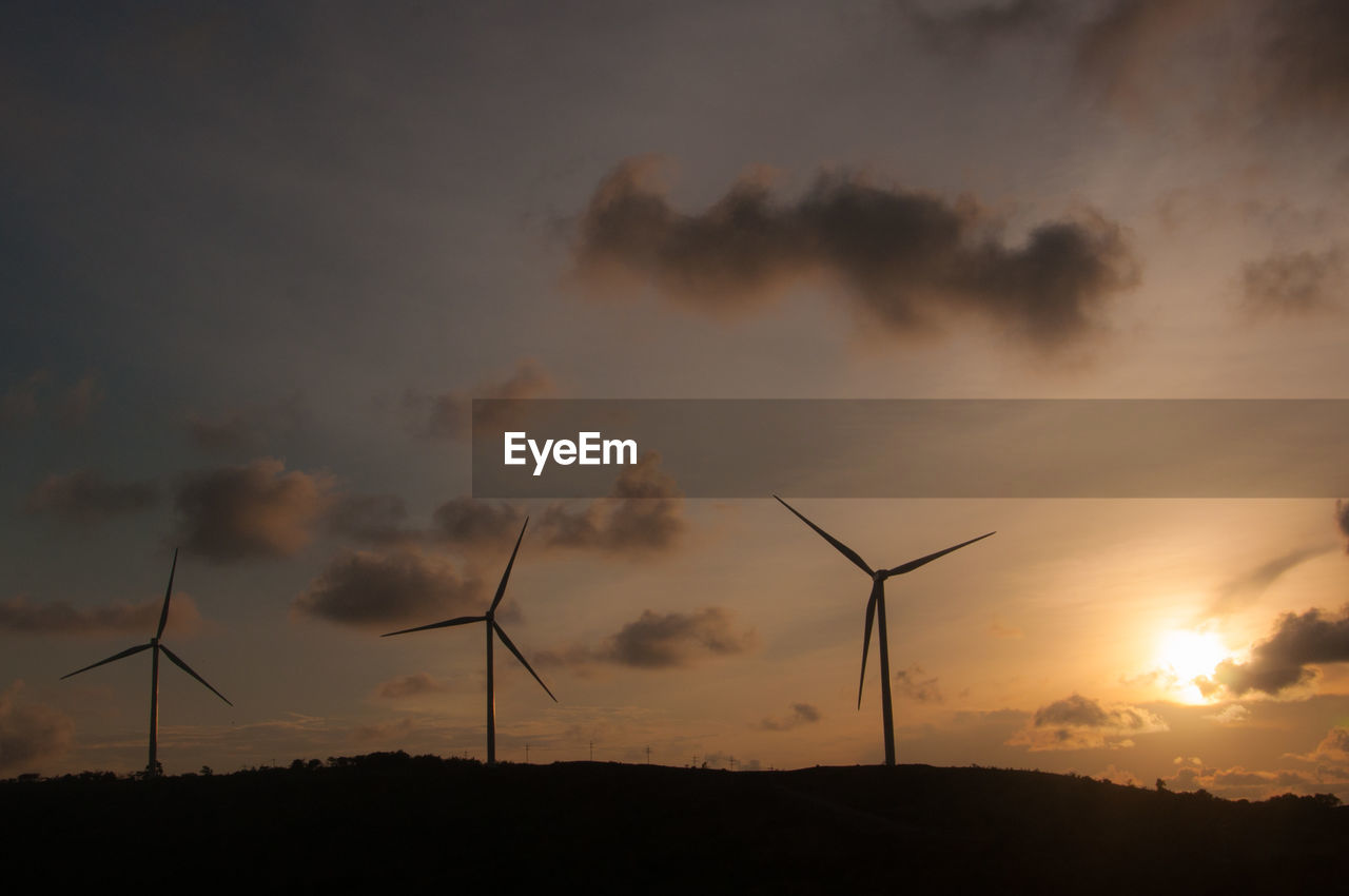 SILHOUETTE OF WIND TURBINES ON LAND