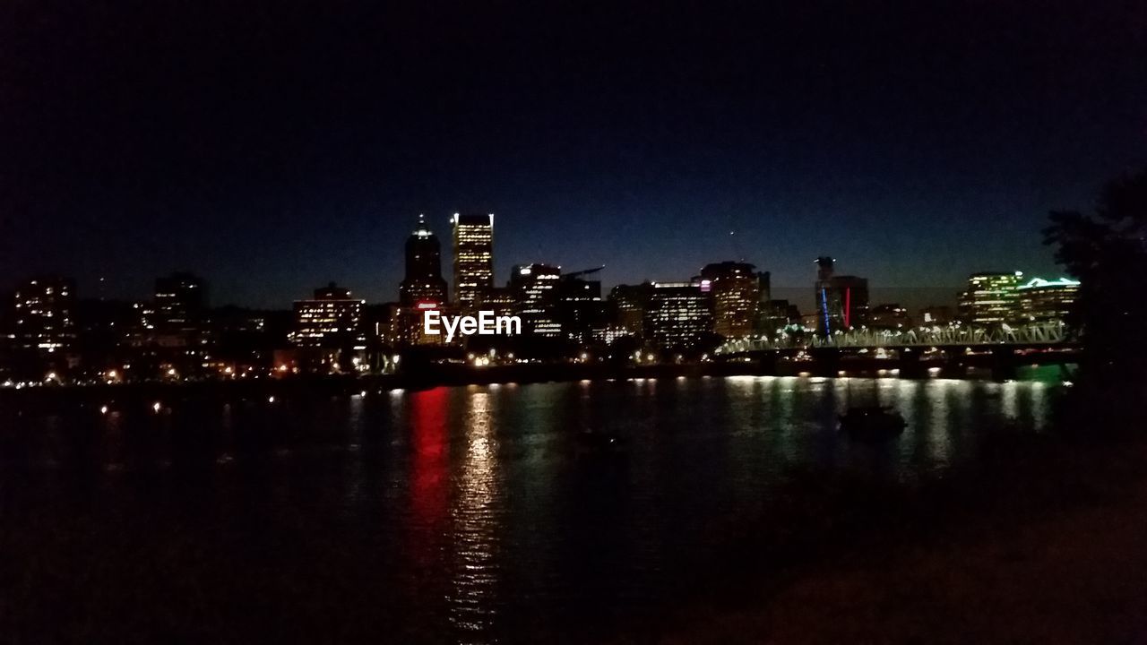 VIEW OF ILLUMINATED CITY AT NIGHT