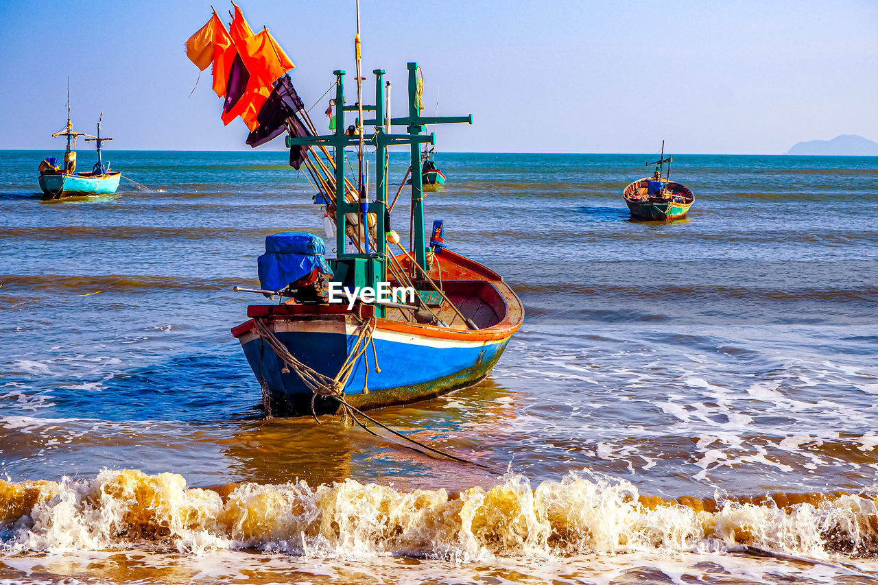 Vibrant reflections traditional fishing boat at the shores of thailand