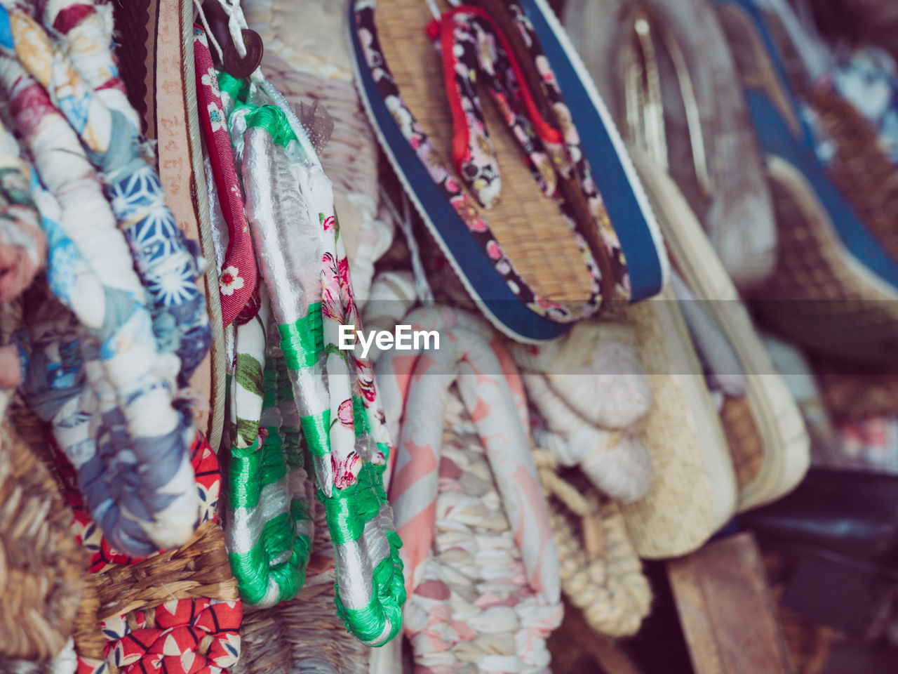 Close-up of colorful flip-flops for sale in market