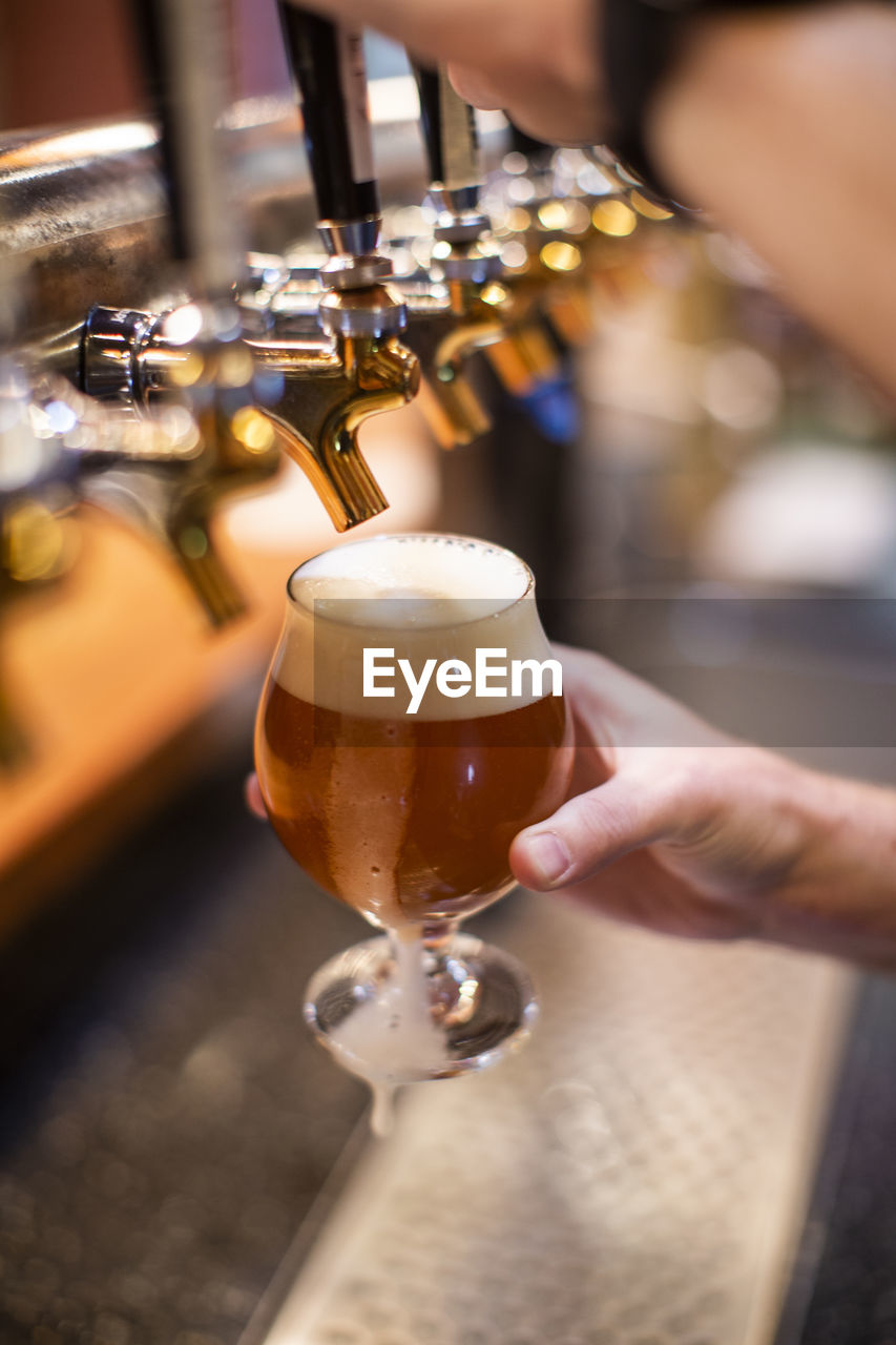 A man pours a beer at a brewery in the dalles, oregon.