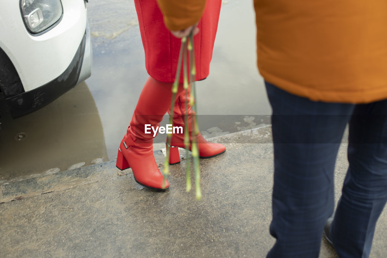 Red boots. red women's clothing. meeting people. romantic mood.