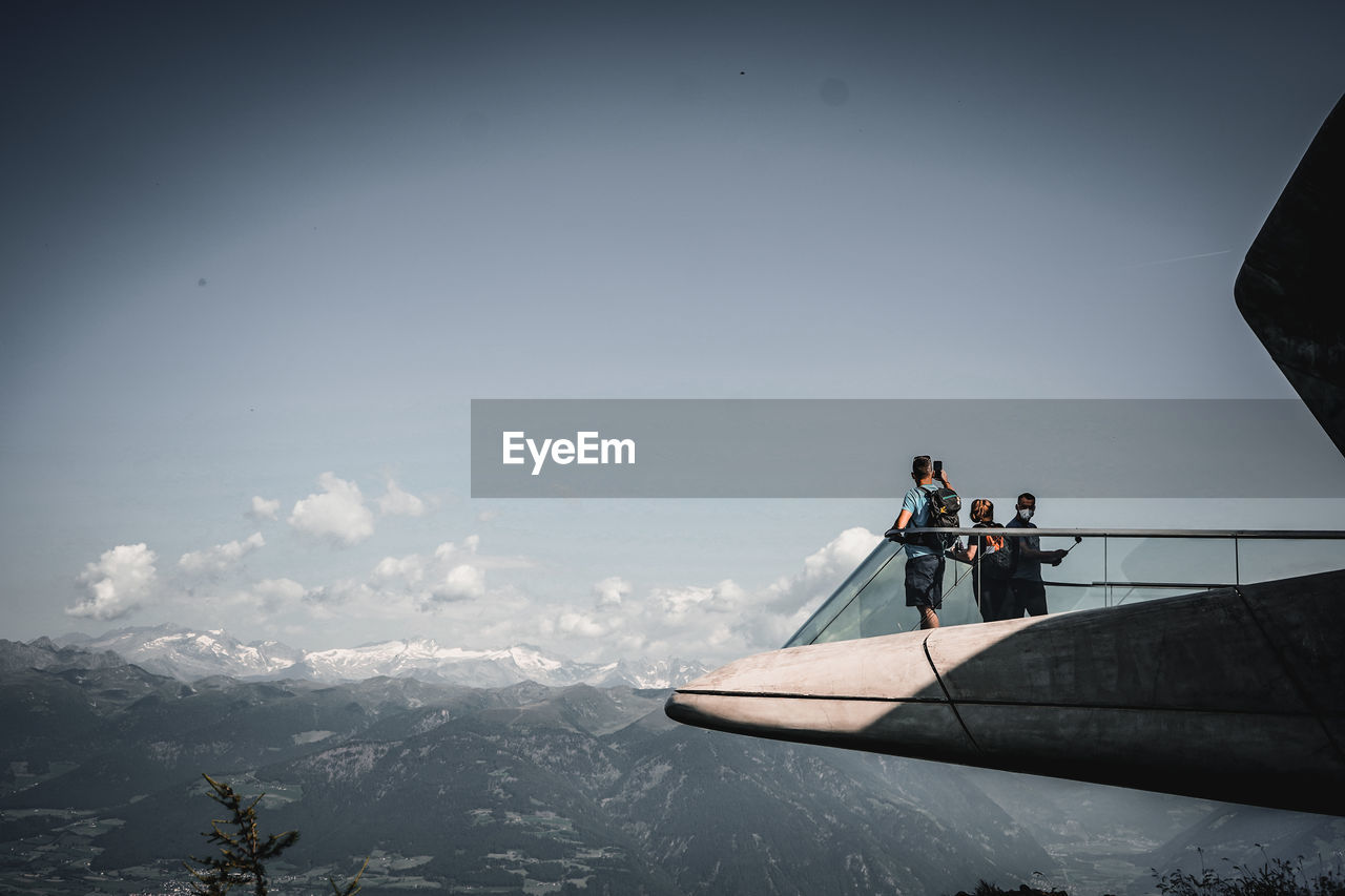 PEOPLE IN BOAT AGAINST SKY