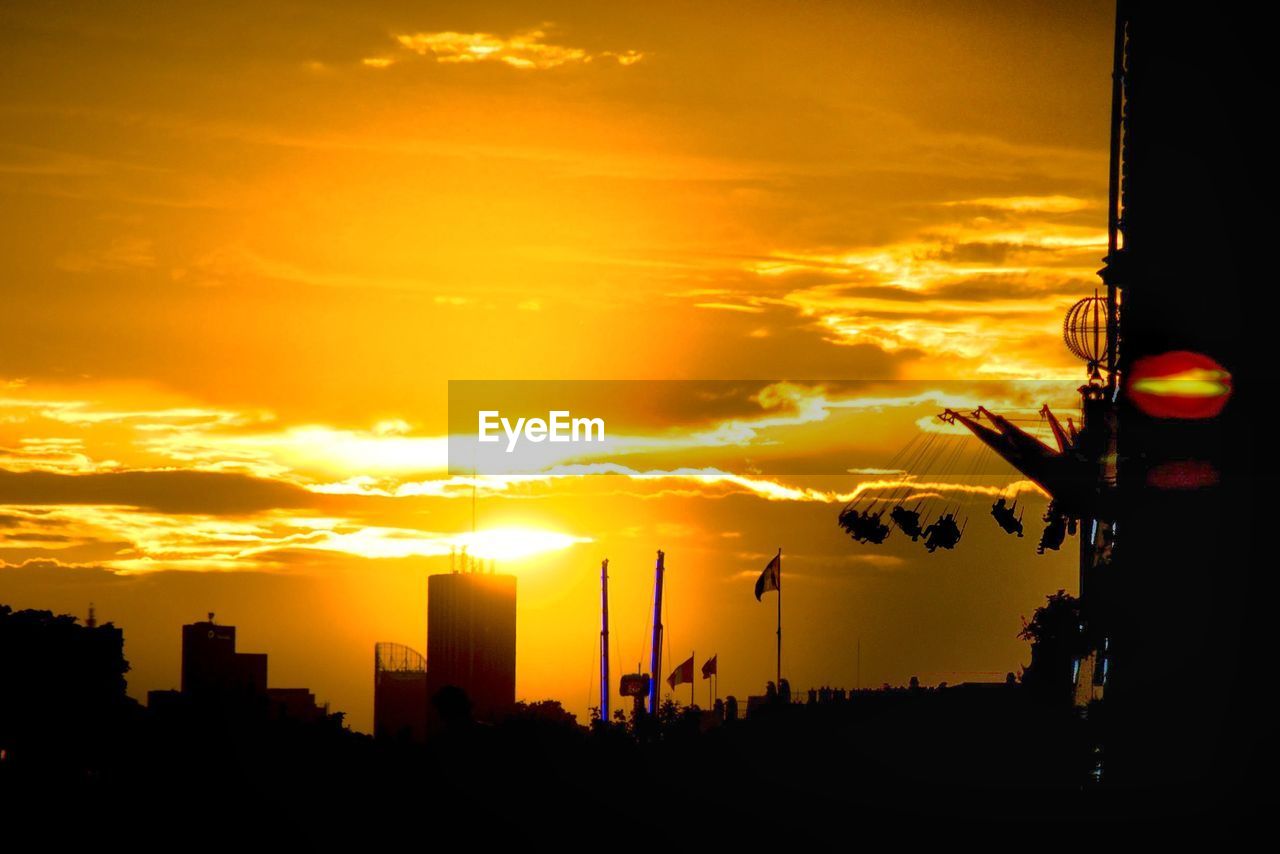 Silhouette cityscape against sky during sunset