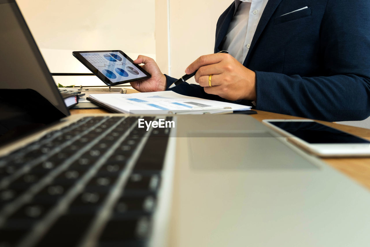 Midsection of business person working at desk