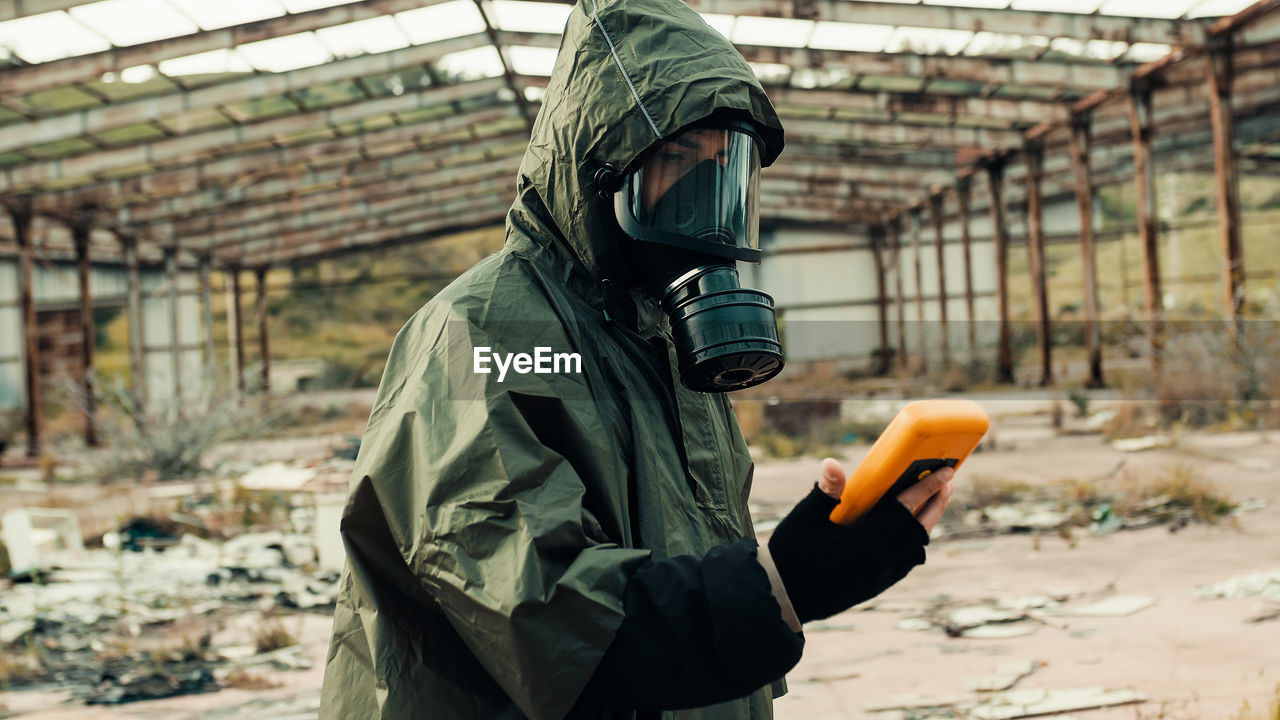 Man with geiger counter in radioactive site