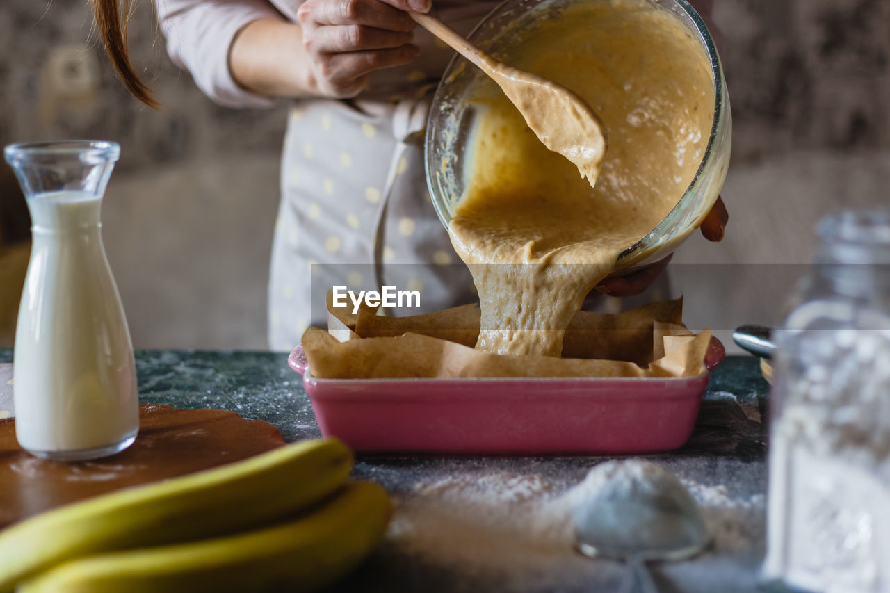 Midsection of woman baking at home