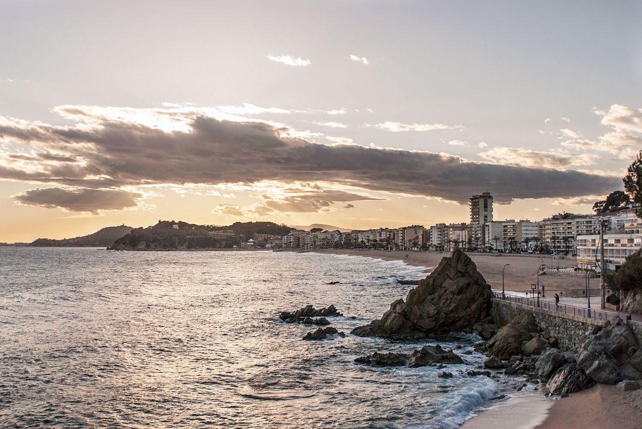 Scenic view of city and sea against sky