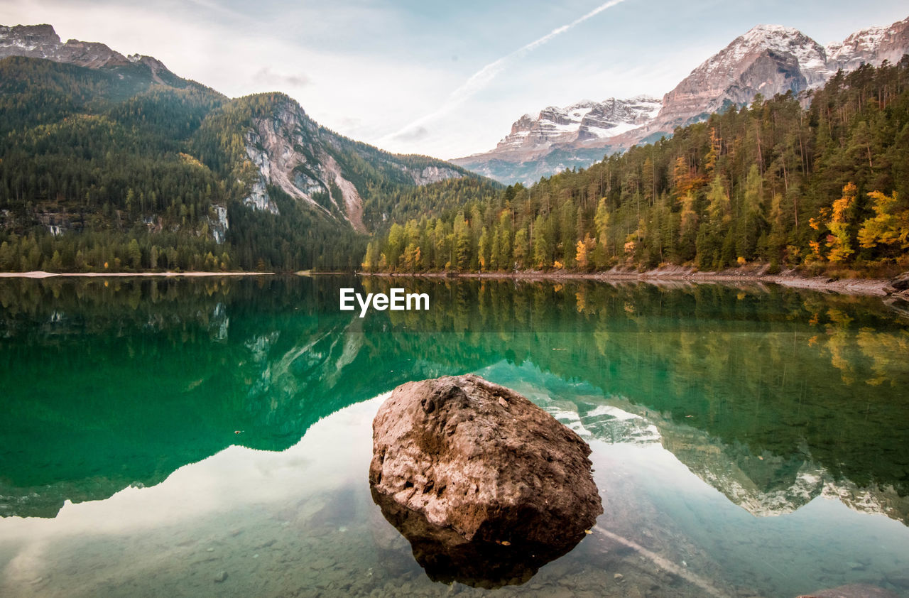 Scenic view of lake and mountains against sky