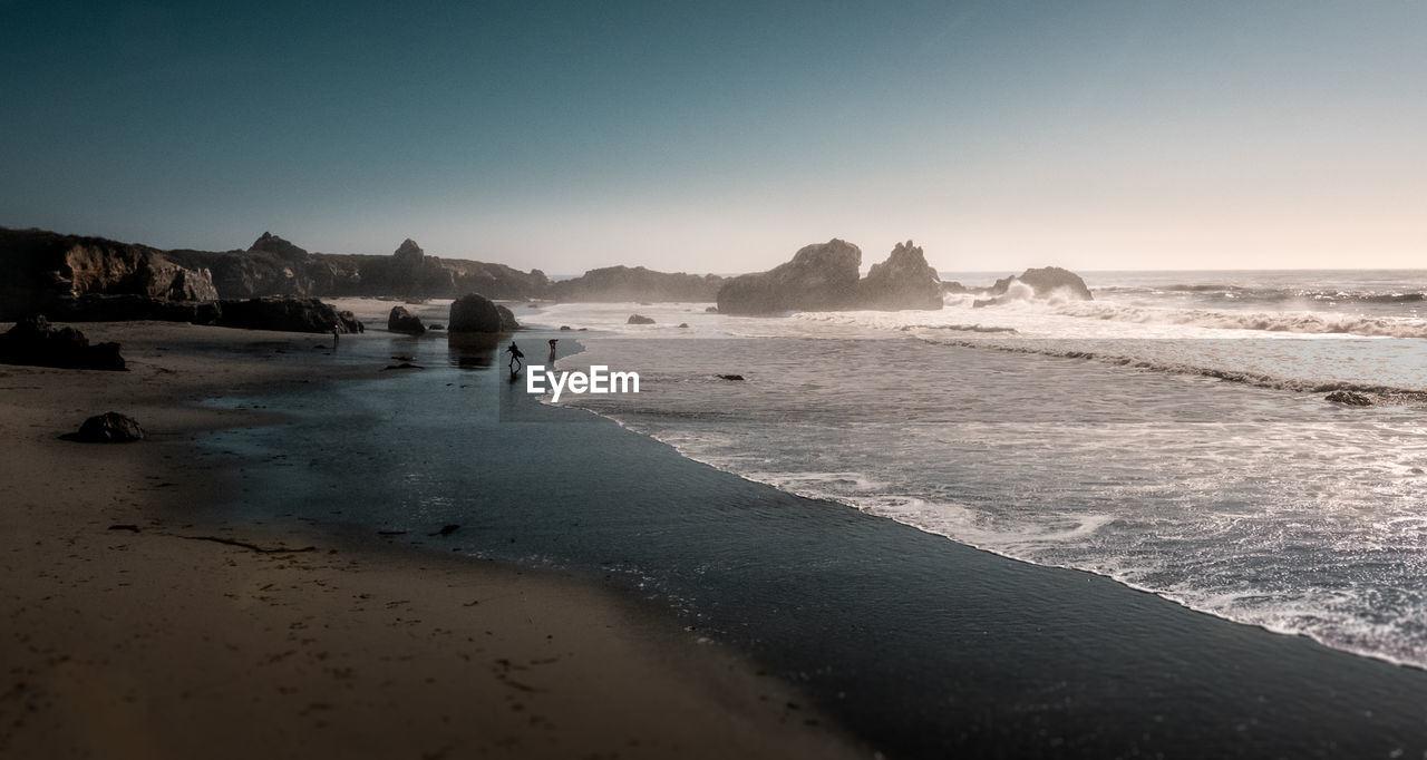 Scenic view of beach against clear sky