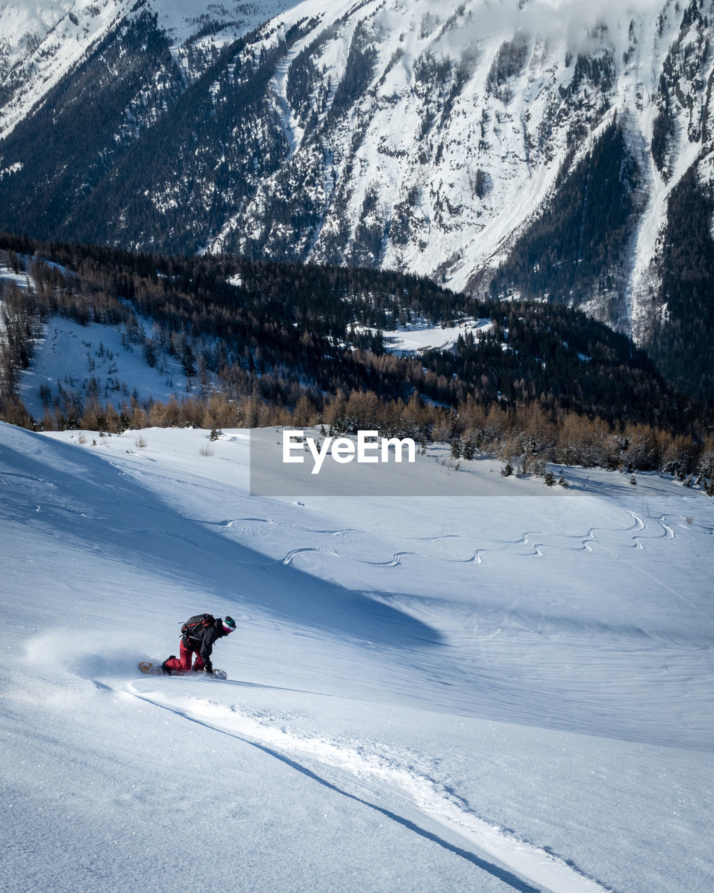 PERSON SKIING ON SNOWCAPPED MOUNTAINS