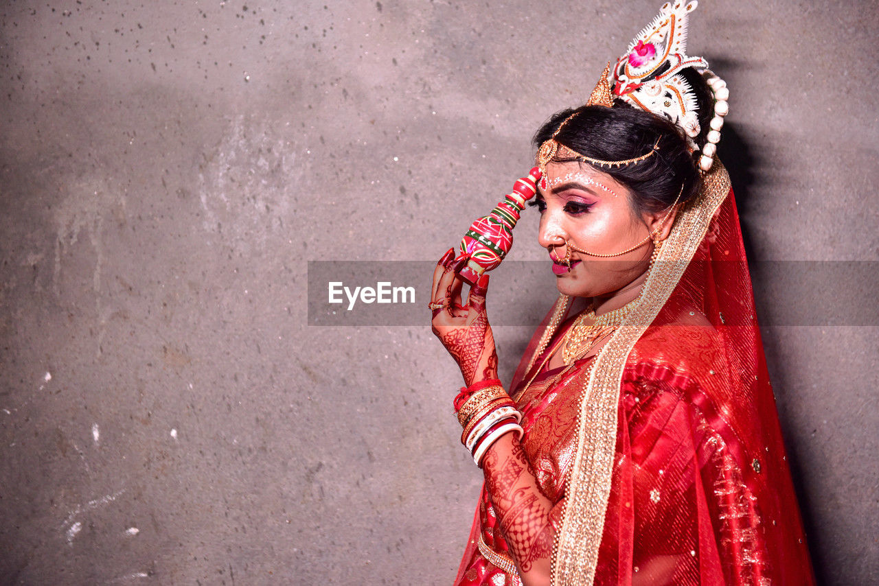 red, one person, women, adult, clothing, young adult, traditional clothing, portrait, fashion, bride, make-up, female, event, celebration, lifestyles, person, arts culture and entertainment, tradition, copy space, fashion accessory, looking, emotion, stage make-up, looking at camera