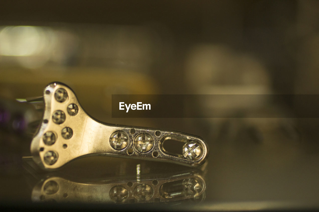 Close-up of metallic equipment on glass table