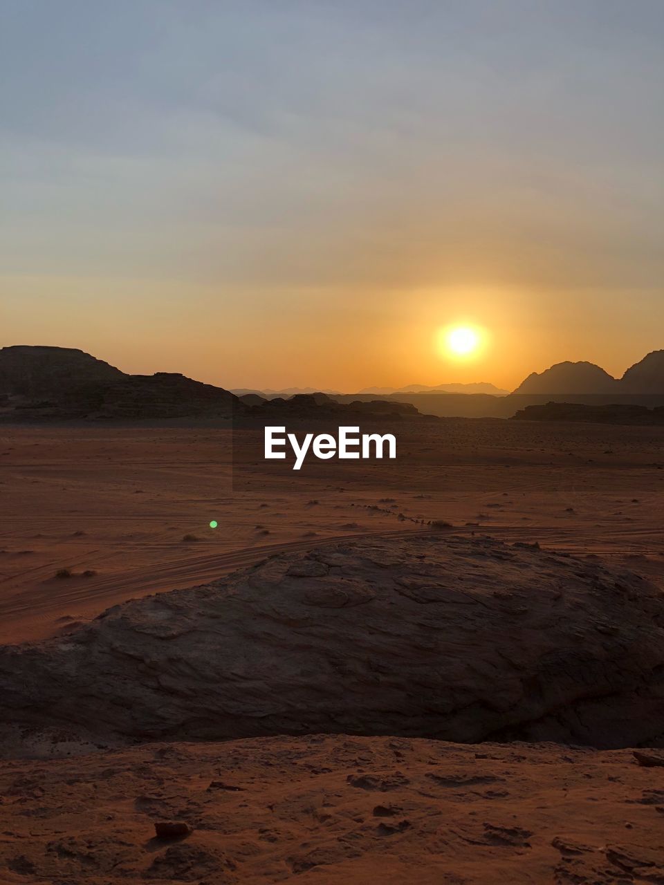 Scenic view of beach against sky during sunset