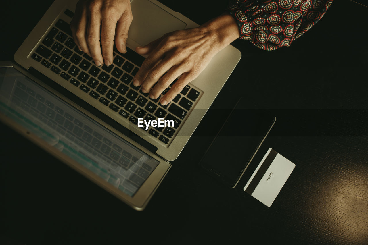 Hands of businesswoman working on laptop in office