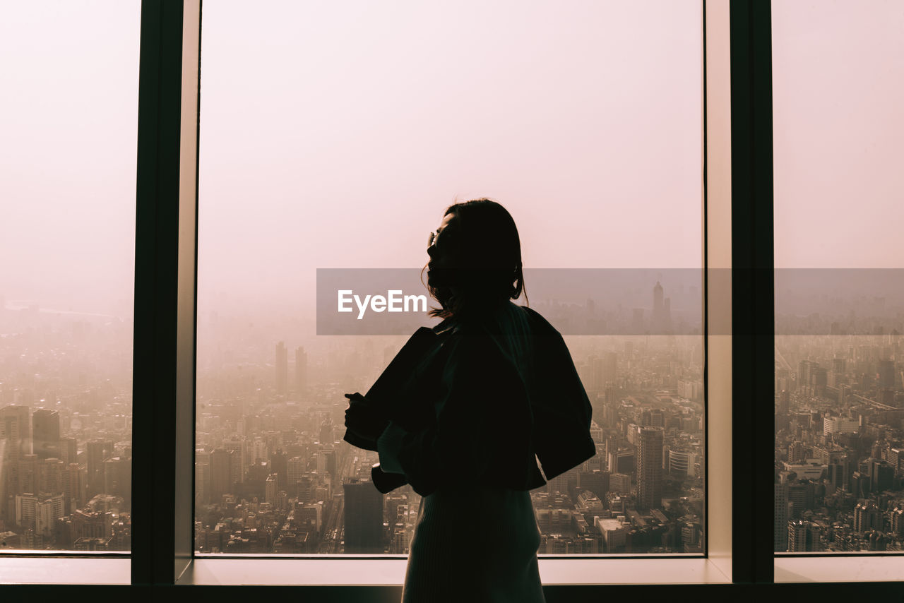 Woman standing by window