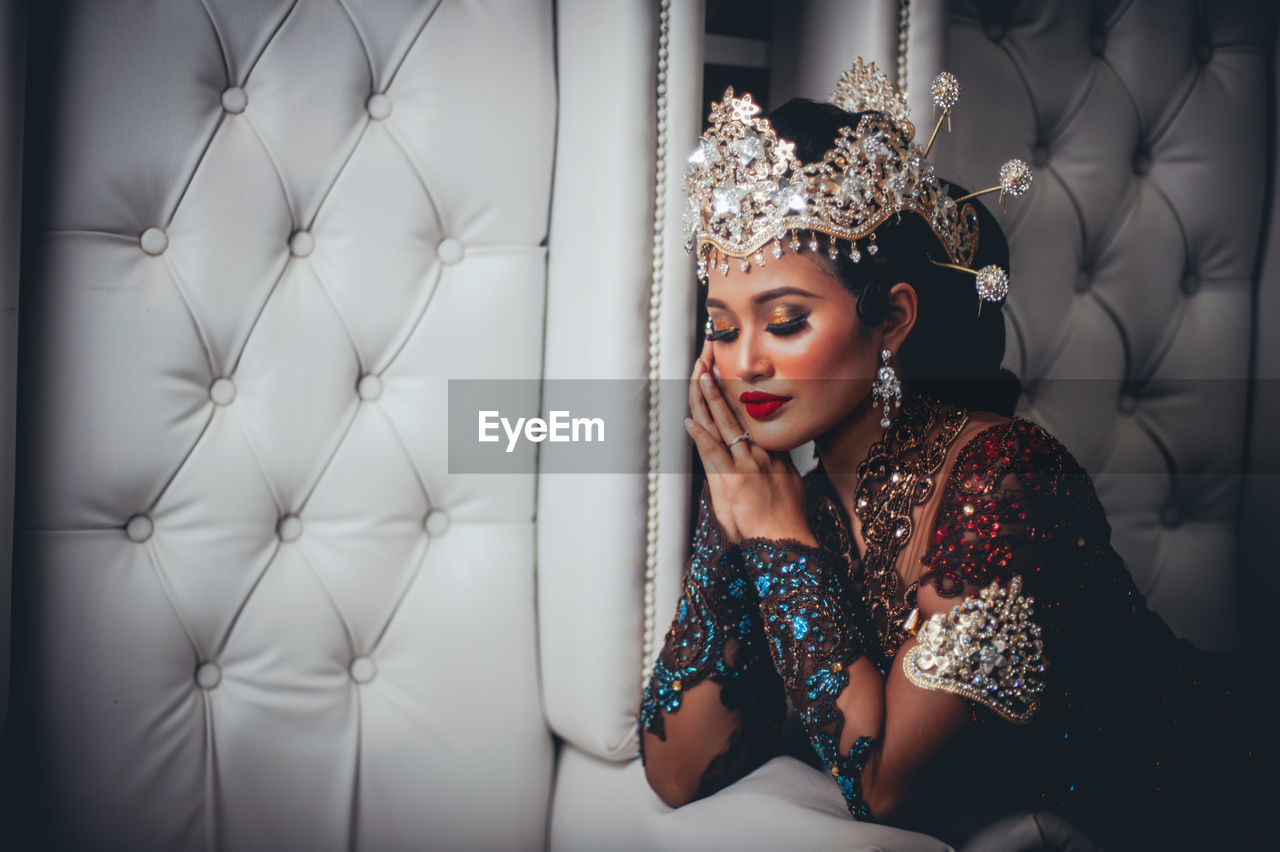Portrait of young woman in traditional malay wedding dress. 