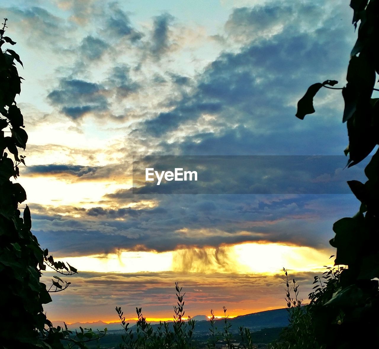 Silhouette landscape against scenic sky