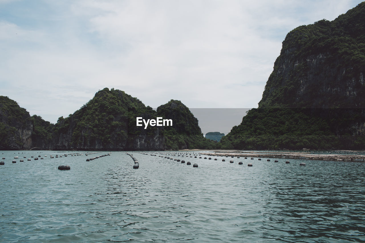 Scenic view of sea and mountains against sky