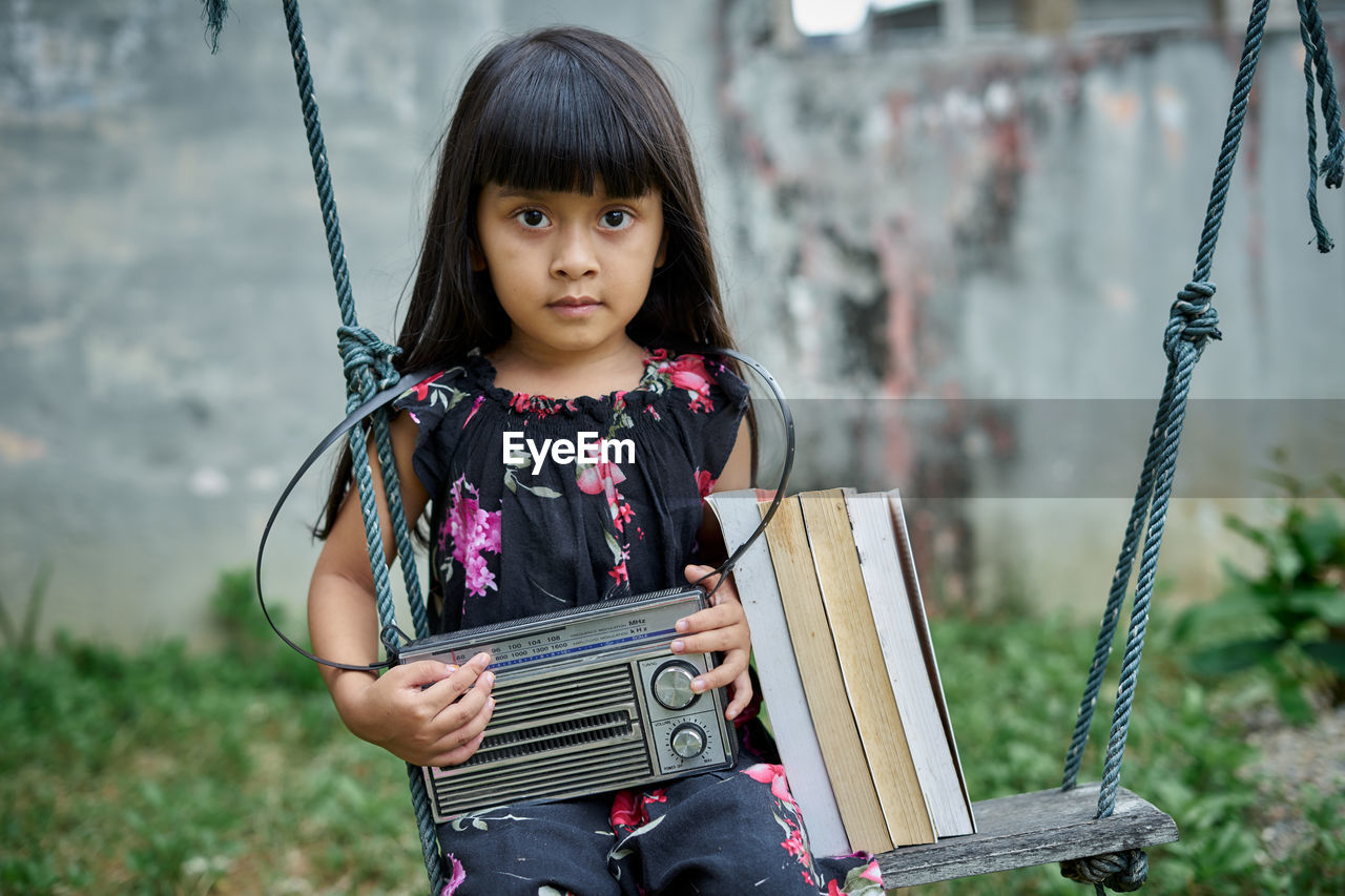 Portrait of cute girl standing outdoors