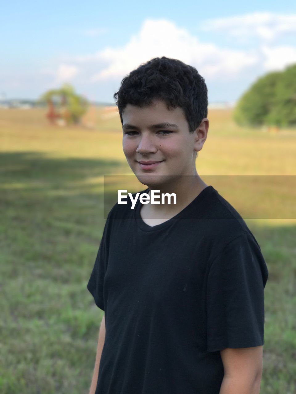Portrait of teenage boy standing on field