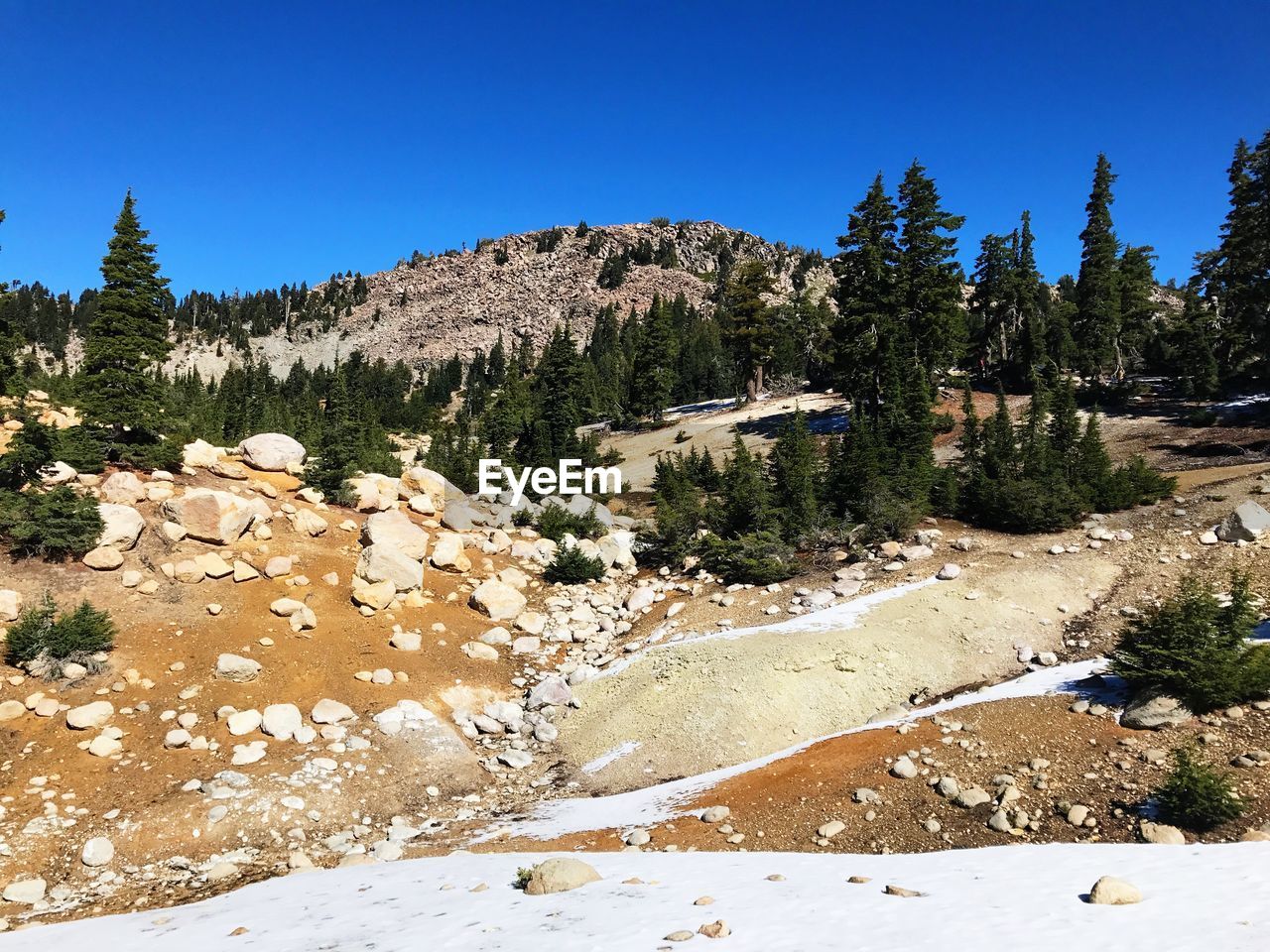 Scenic view of mountains against clear blue sky