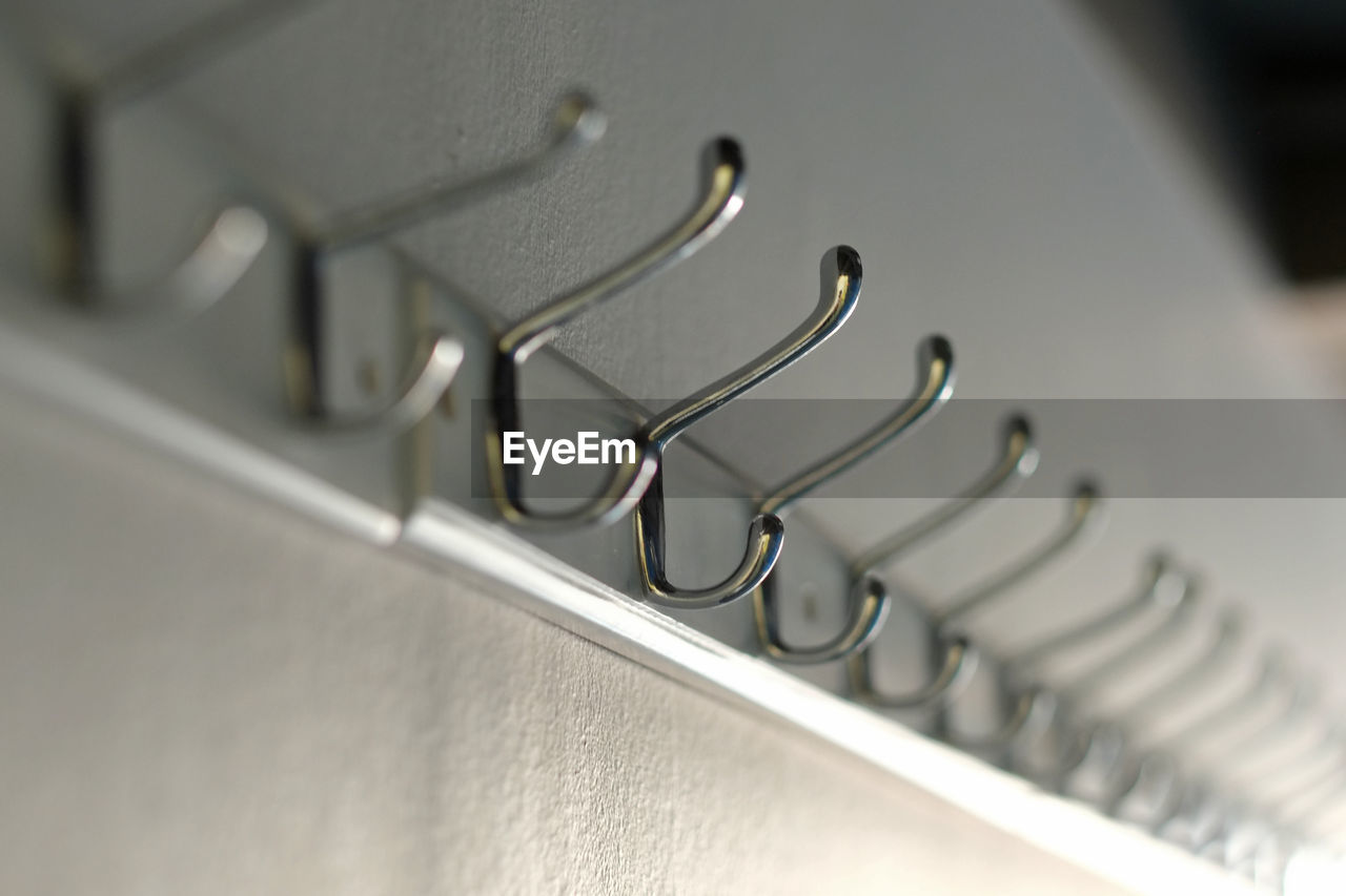 Close-up of hooks mounted on wall