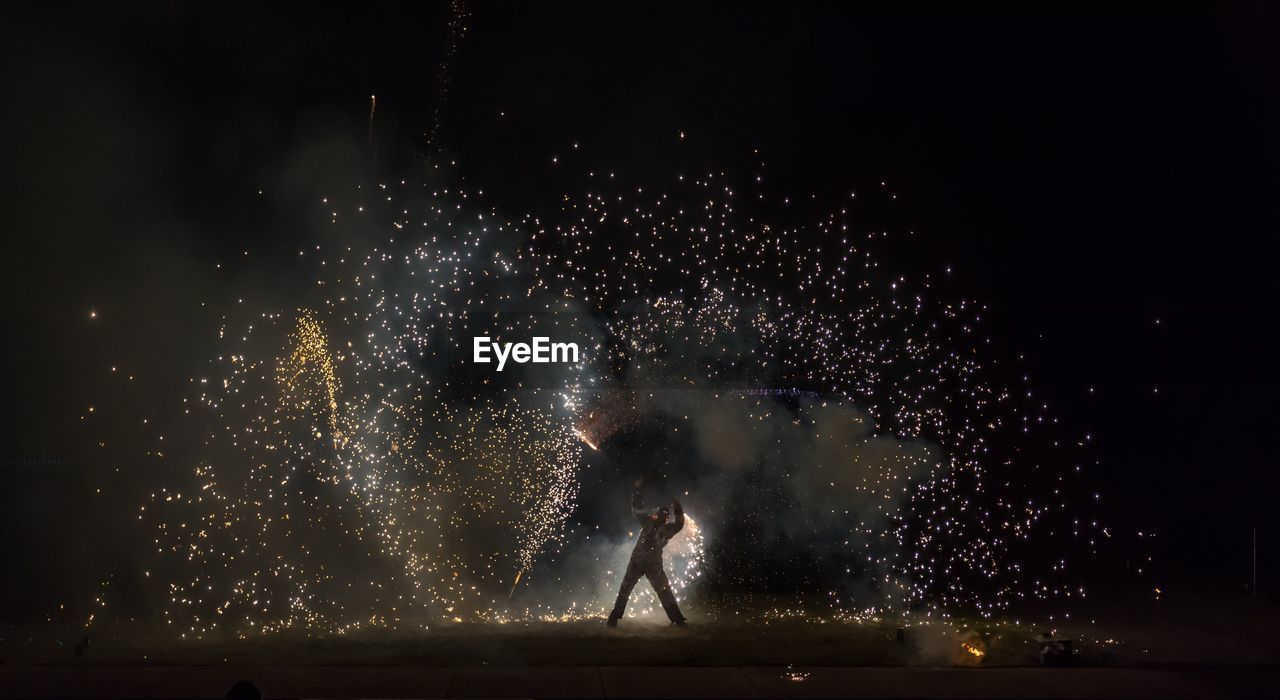 Man with sparks at night