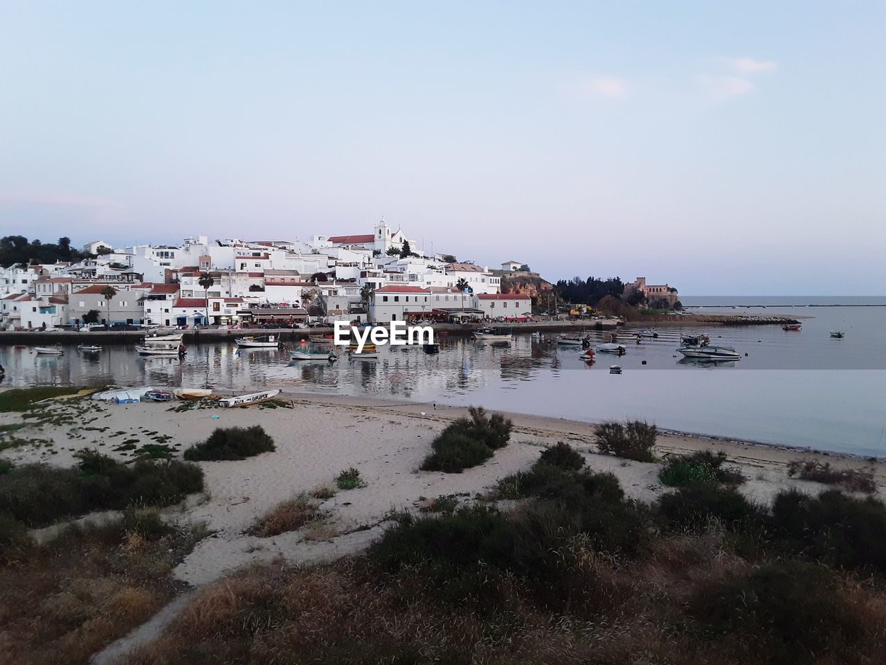 VIEW OF BUILDINGS BY SEA AGAINST SKY