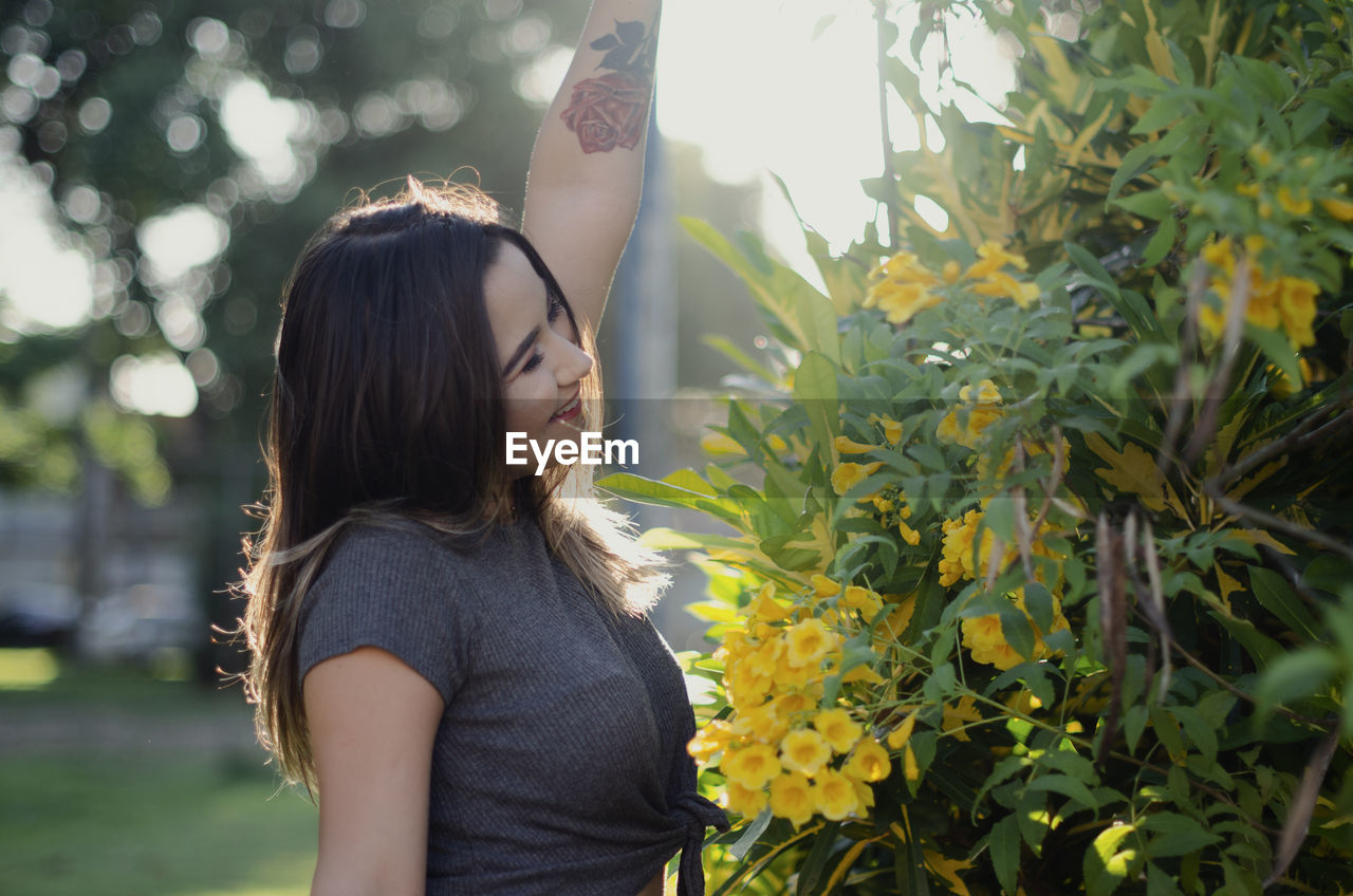 YOUNG WOMAN STANDING ON PLANT