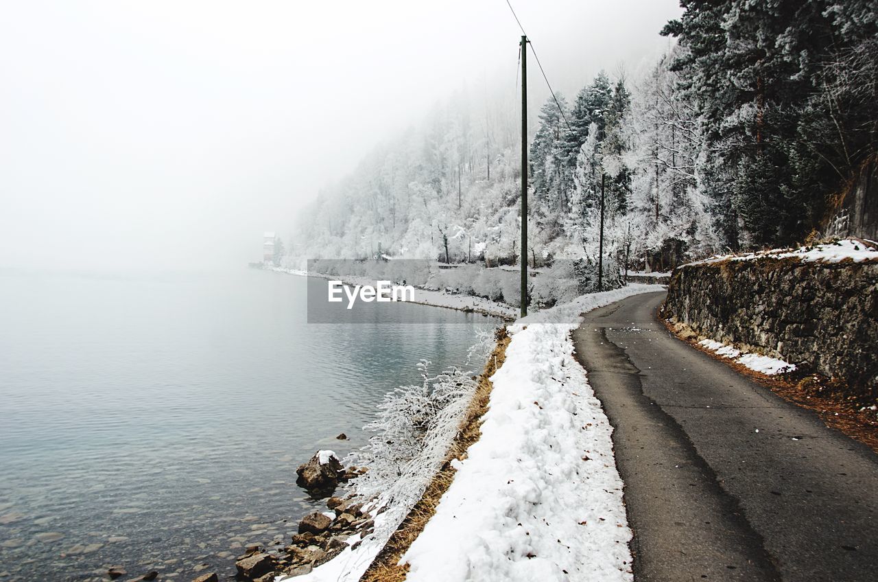 Scenic view of frozen lake against sky during winter