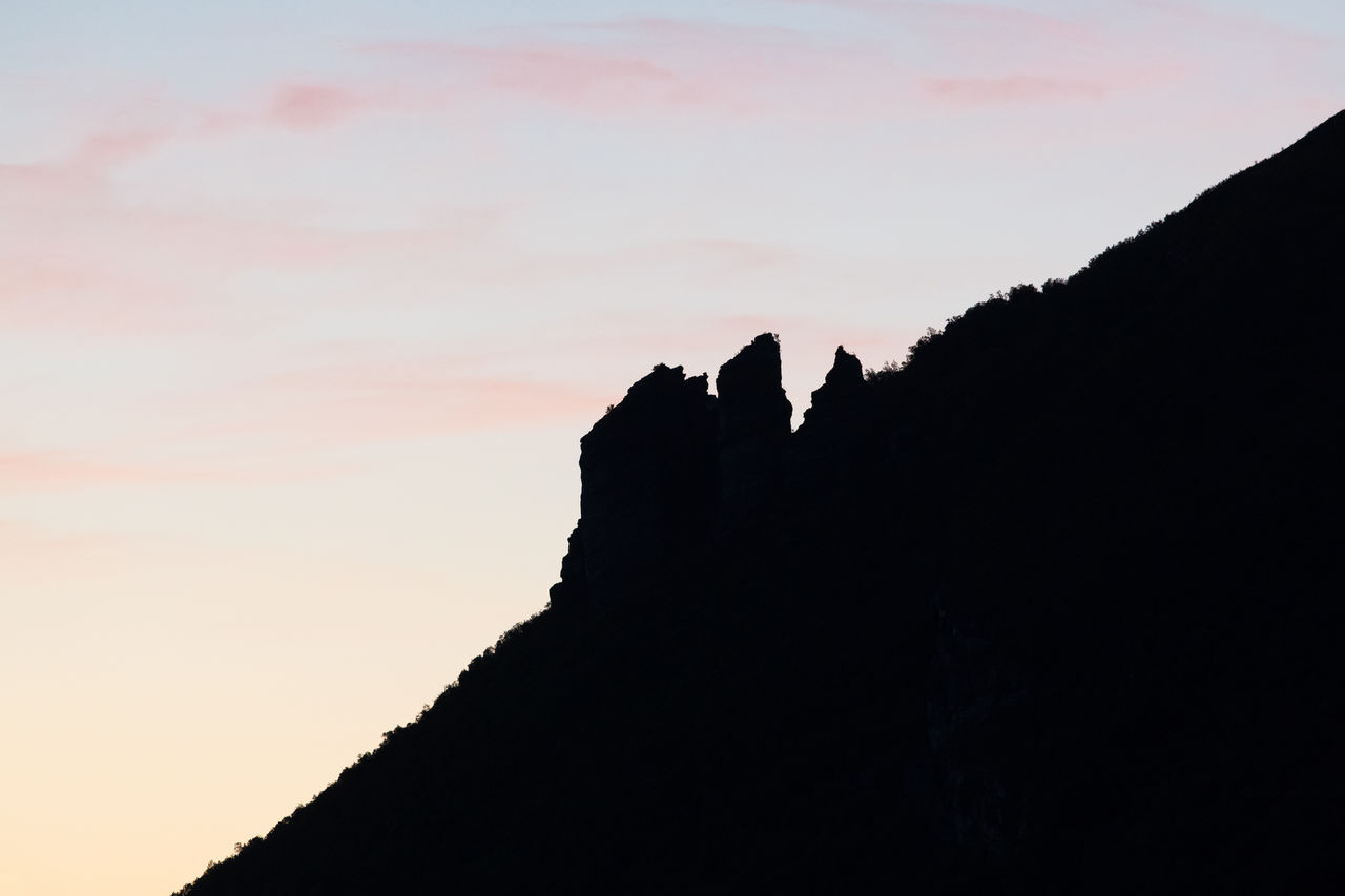 Low angle view of silhouette mountain against sky during sunset