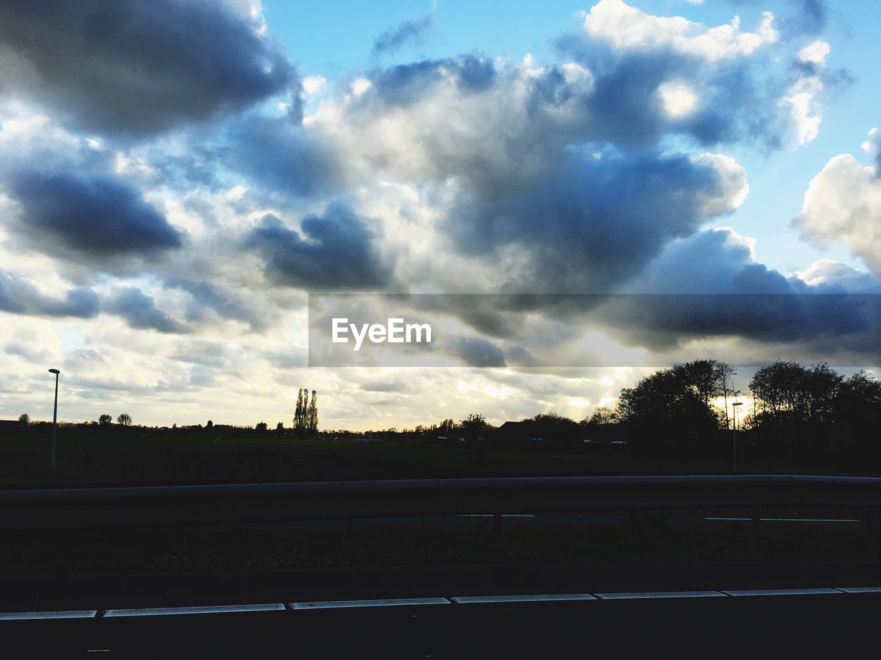 SCENIC VIEW OF DRAMATIC SKY OVER SILHOUETTE TREES