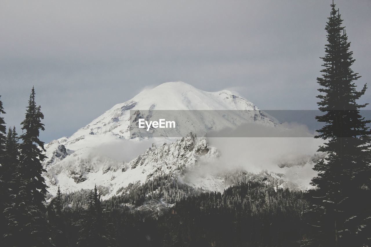 Scenic view of snow covered mountains against sky