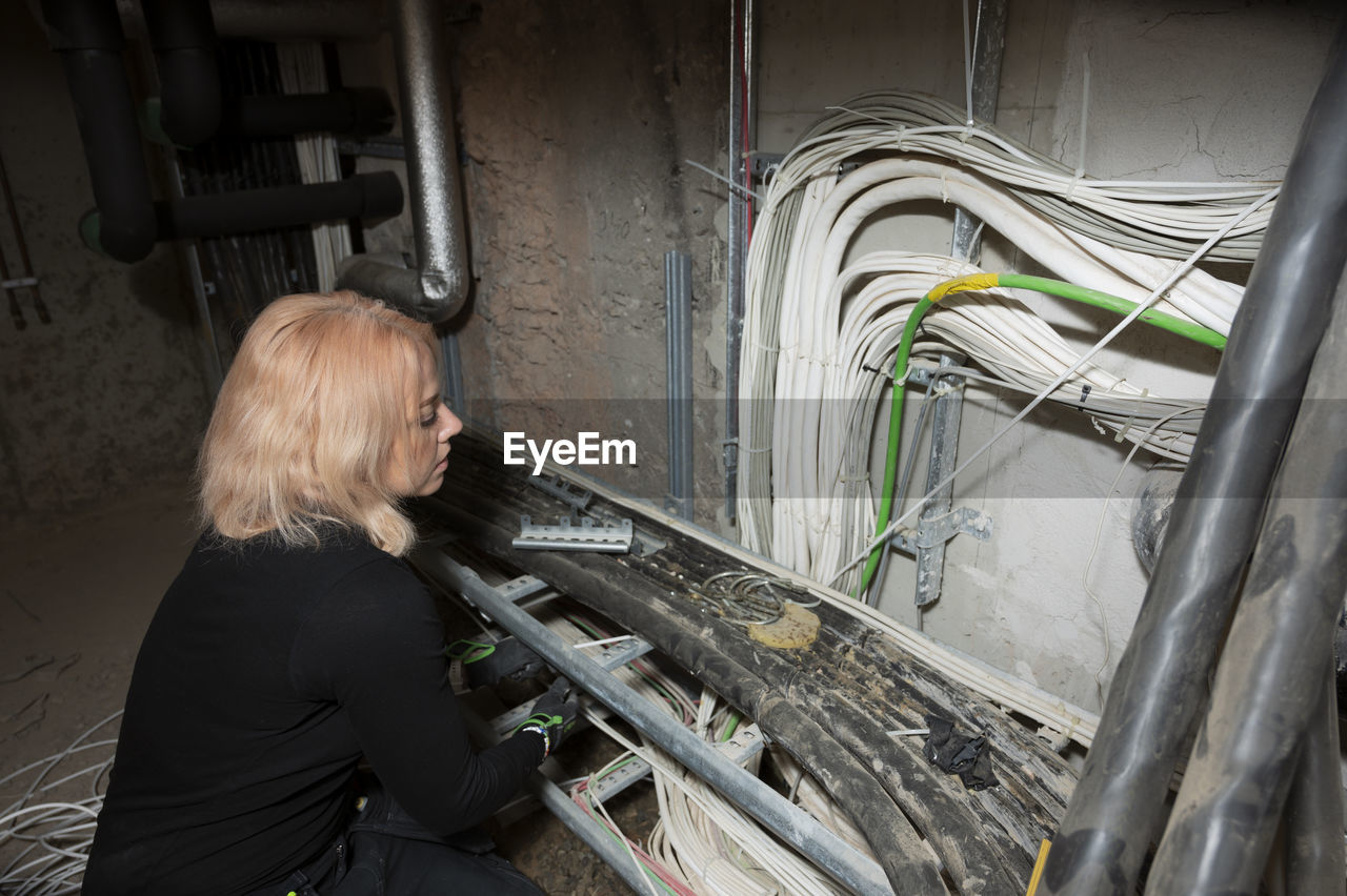 Female electrician at work