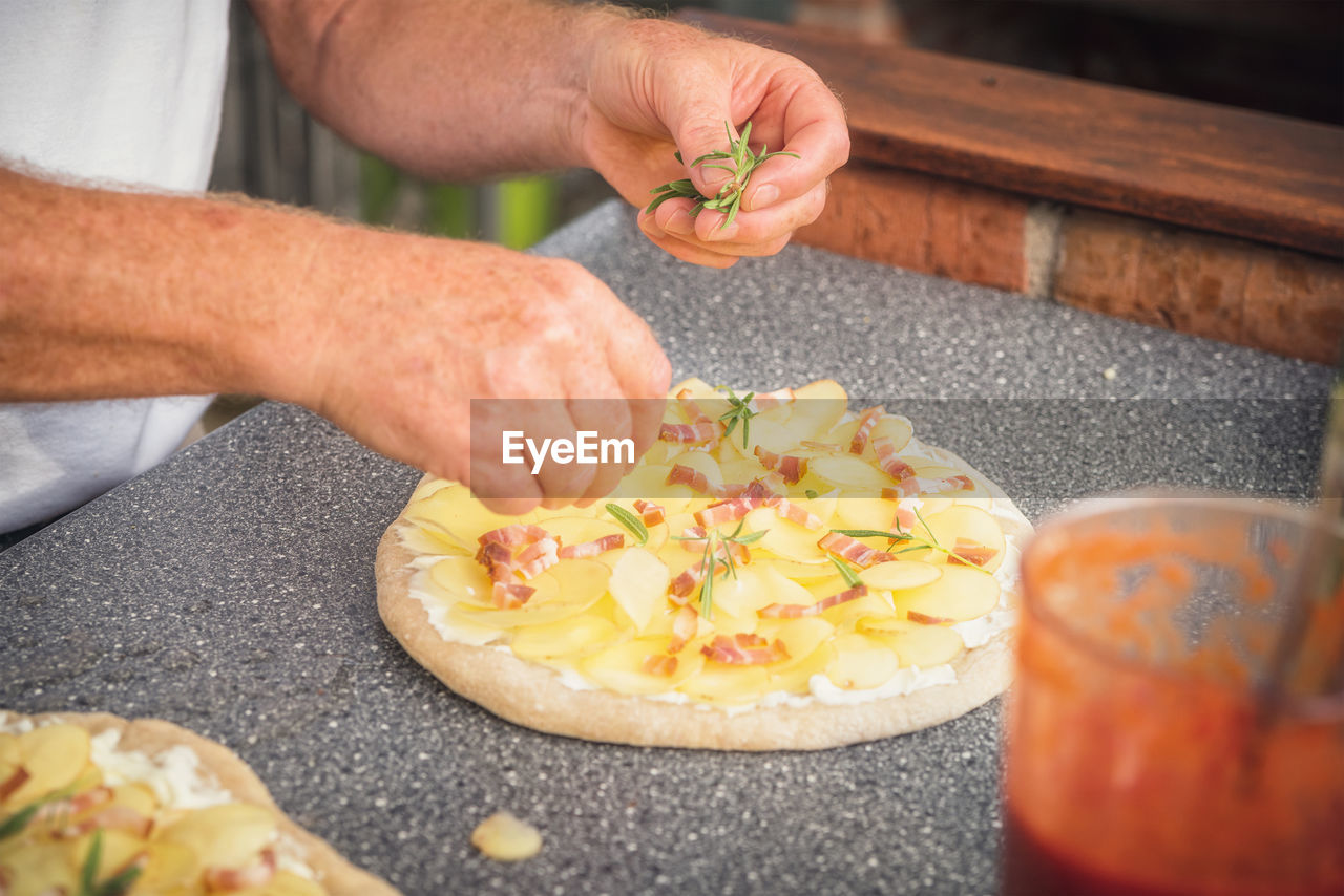 midsection of man preparing food in kitchen