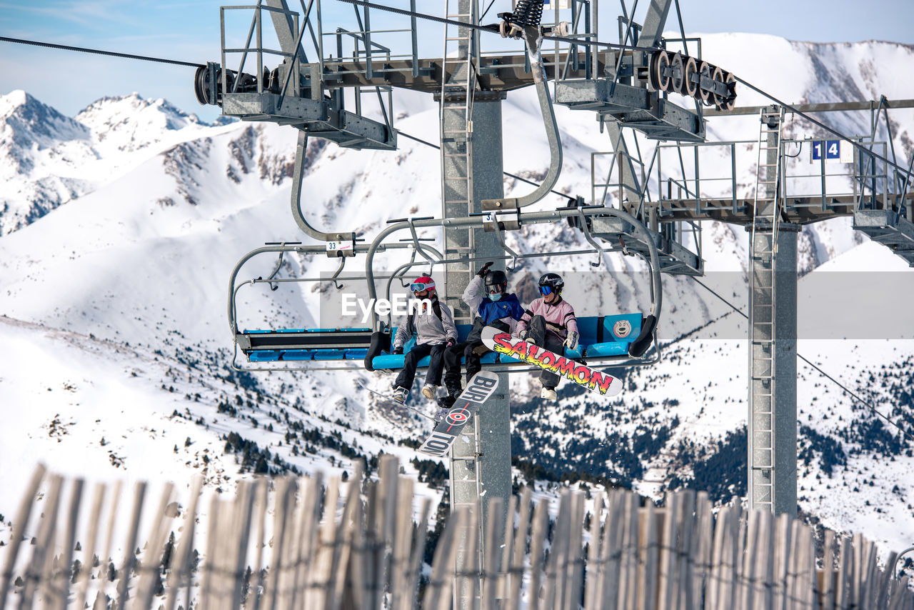 MEN WORKING ON SNOW COVERED MOUNTAIN