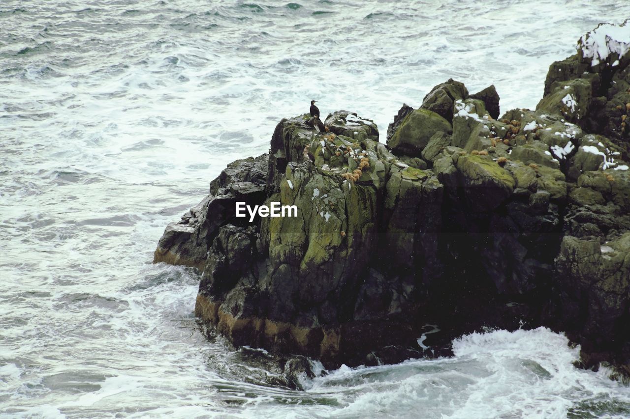 High angle view of rock formations by sea