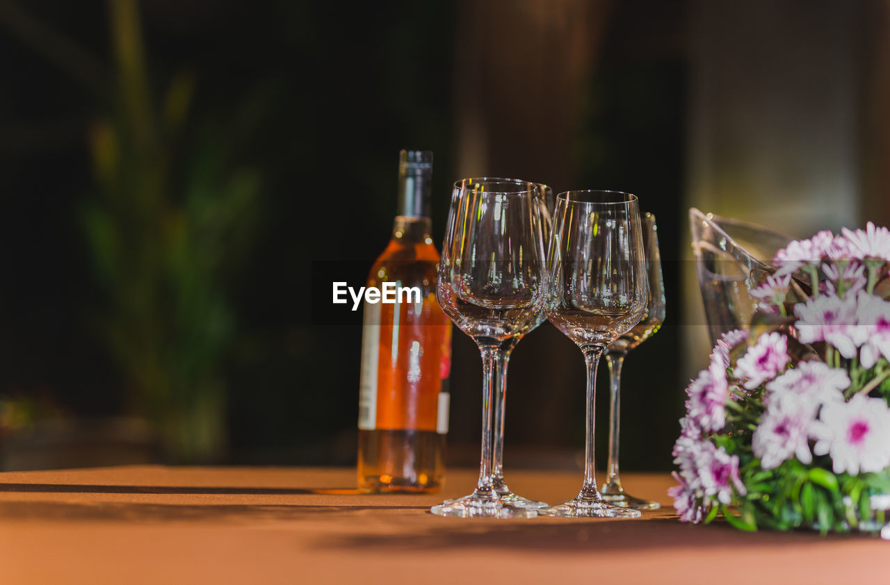 Empty wine glasses and bottle of wine on table.