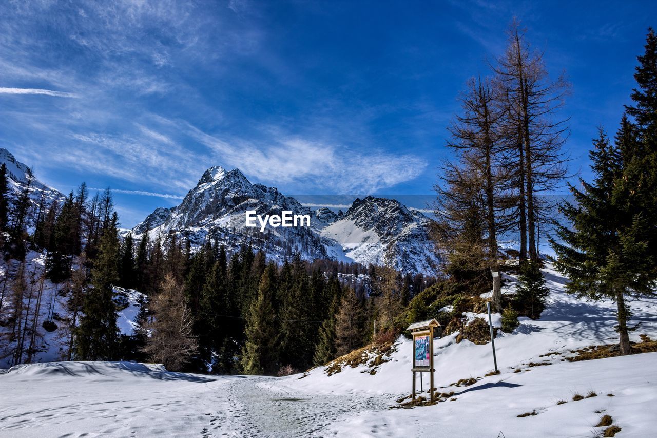 Scenic view of snow covered mountains against sky