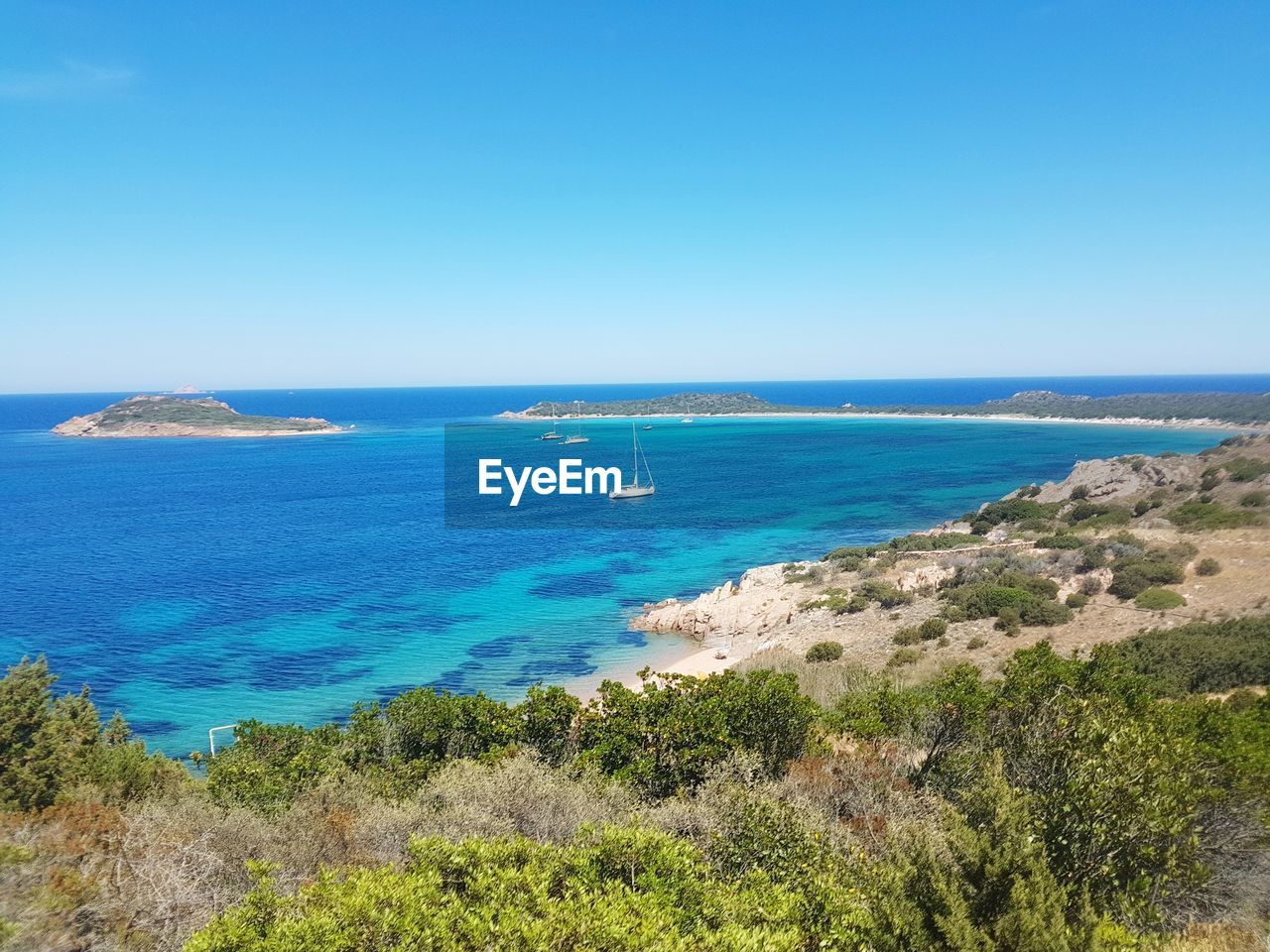 Scenic view of sea against clear blue sky