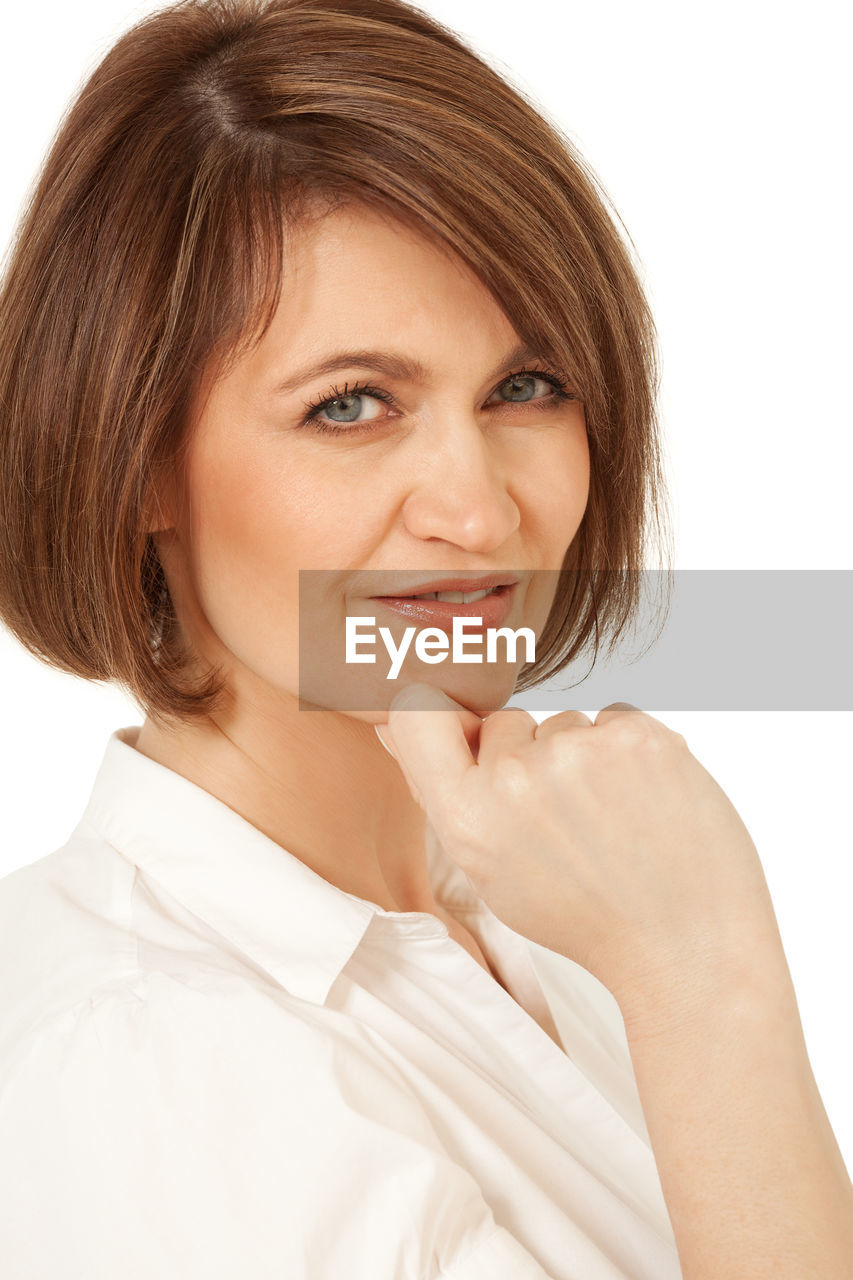 Close-up portrait of beautiful woman against white background