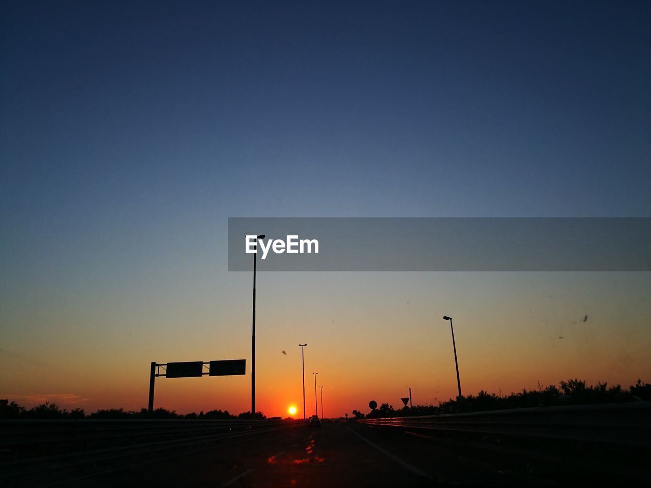 Street against sky during sunset