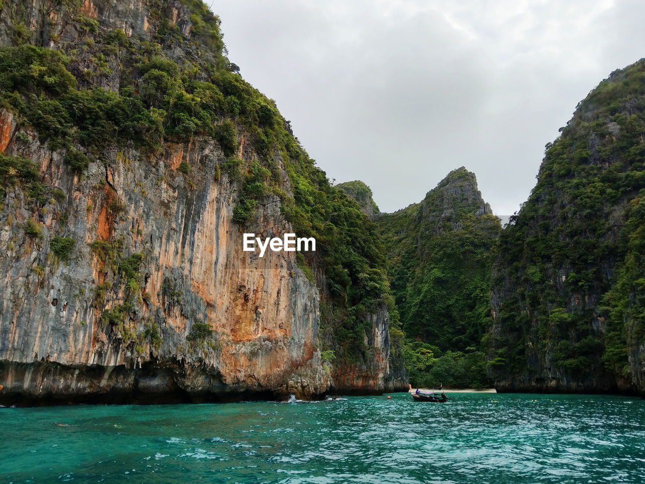 Scenic view of sea and mountains against sky